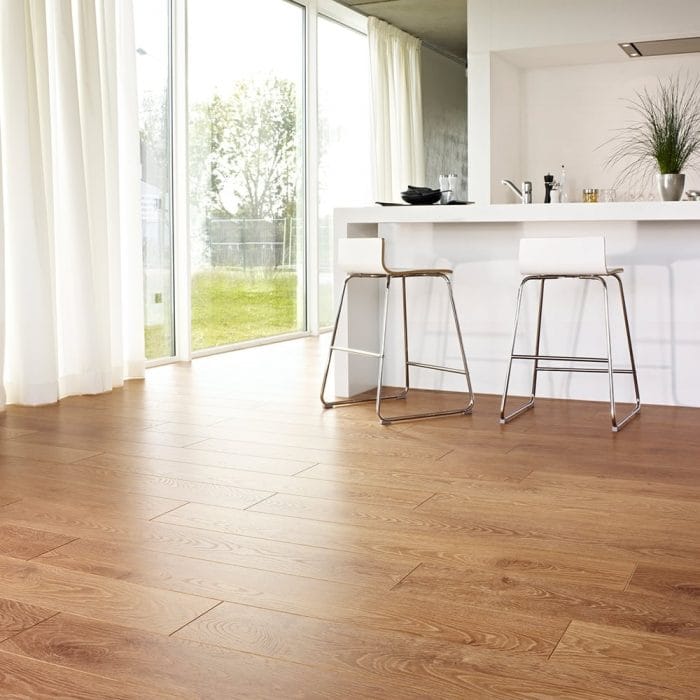 Oak laminate flooring in a mordern white kitchen